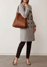 A studio style photo of the buttery soft Australian made Maple Bespoke Tote from Charlie Middleton on a model.