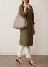 A studio style photo of the buttery soft Australian made Taupe Bespoke Tote from Charlie Middleton on a model.