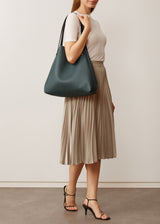 A studio style photo of the buttery soft Australian made Bottle Nappa Bespoke Tote from Charlie Middleton on a model.