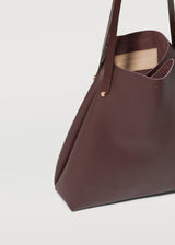 A cut view of the Burgundy Vogue Bespoke Tote, highlighting the details of the full grain leather, handle and hardware from Charlie Middleton.