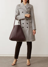 A model showcasing the Burgundy Vogue Bespoke Tote from Charlie Middleton.