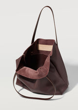 A close view of the Burgundy Vogue Bespoke Tote. Showing the inside pocket of the tote bag and Charlie Middleton logo.
