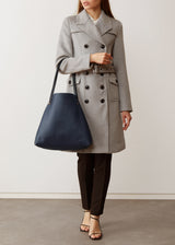 A model showcasing the buttery soft Australian Made Navy Nappa Bespoke Tote from Charlie Middleton.