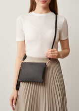 A studio style photo of the Black Nappa Essentials Crossbody bag from Charlie Middleton.